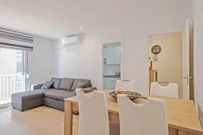 a living room with a couch and a table and chairs at Dialez Holidays - Colomeres in Gavà