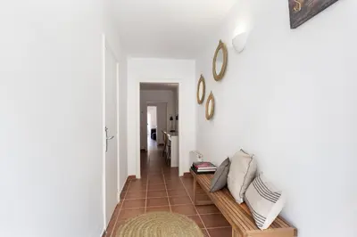 a living room with a couch and a hallway at Casa Rosari I - Jardín & Parking Privado in Vilassar de Mar
