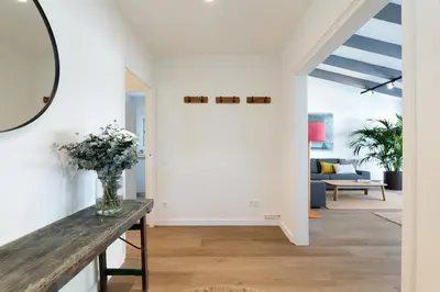 a living room with white walls and a vase of flowers at Rosari II - Vivienda Privada con Parking in Vilassar de Mar