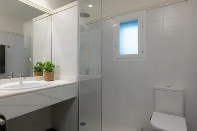 a bathroom with a glass shower and a sink at Rosari II - Vivienda Privada con Parking in Vilassar de Mar