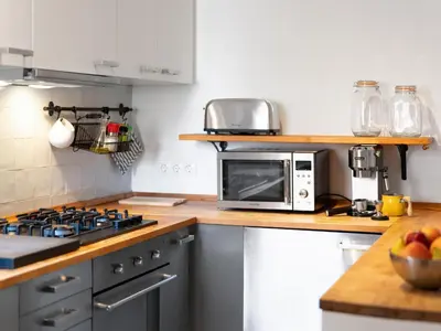 a kitchen with a stove and a microwave at Cosy Sants Apartment in Barcelona