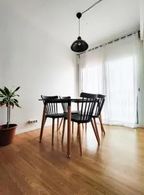 a dining room table with two chairs and a potted plant at Apartamento en Montgat - Serenity Stays in Montgat