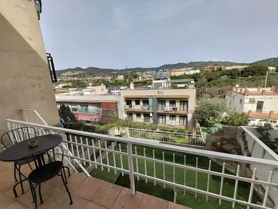 a balcony with a table and a view of a city at Apartamento en Montgat - Serenity Stays in Montgat