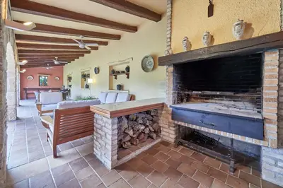 a living room with a fireplace and a couch at LuxRural Montserrat | Piscina con Vistas Únicas in Marganell