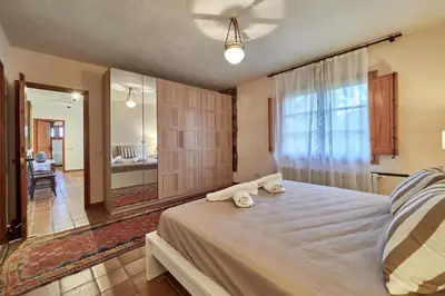 a bedroom with a bed with two towels on it at LuxRural Montserrat | Piscina con Vistas Únicas in Marganell