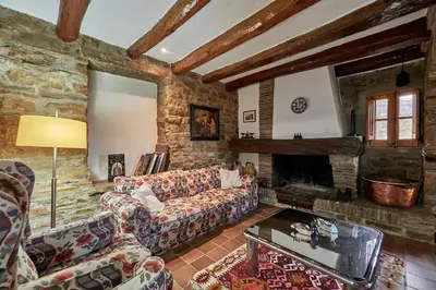 a living room with a couch and a fireplace at LuxRural Montserrat | Piscina con Vistas Únicas in Marganell