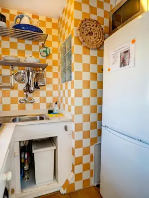 a kitchen with a sink and a refrigerator at Las Terracitas Apartment by Hello Homes Sitges in Sitges