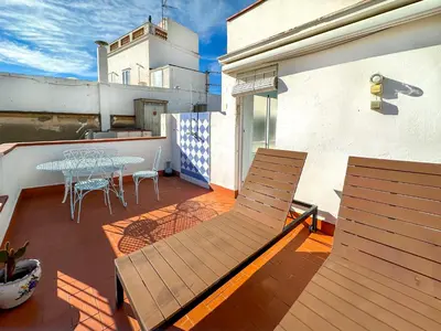 a patio with a table and chairs on a balcony at Las Terracitas Apartment by Hello Homes Sitges in Sitges