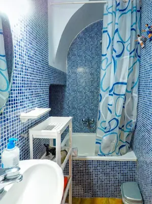 a blue and white bathroom with a sink and a shower at Las Terracitas Apartment by Hello Homes Sitges in Sitges