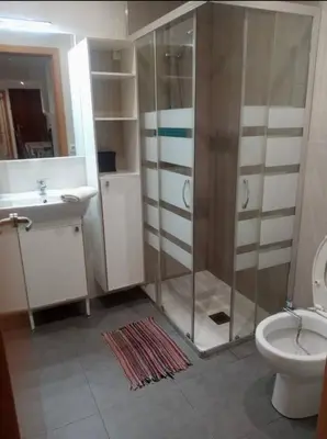 a kitchen with a sink and a white refrigerator at Bon Casa en Bon Pastor in Barcelona