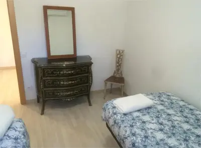 a small room with two beds and a window at Bon Casa en Bon Pastor in Barcelona
