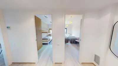a white room with a hallway and a bedroom at Impressive apartment for 6 in Gracia in Barcelona
