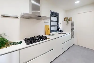 a white kitchen with a stove and a sink at Impressive apartment for 6 in Gracia in Barcelona