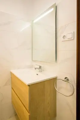 a bathroom with a sink and a mirror at New renovate apartment near of the sea in Barcelona