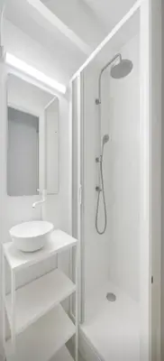 a white bathroom with a sink and a shower at Modern and Elegant Barcelona Apartment in Barcelona