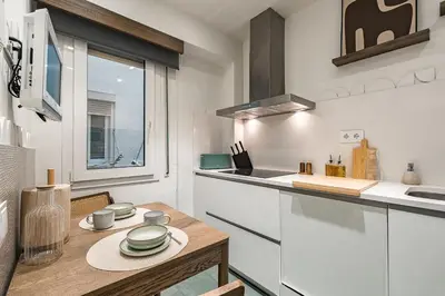 a kitchen with a table and a counter top at Sant Joan Design Apartment in Barcelona