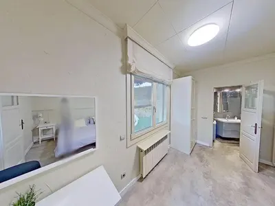 a white room with a bed and a window at Premium Habitat Les Villes in Arenys de Mar