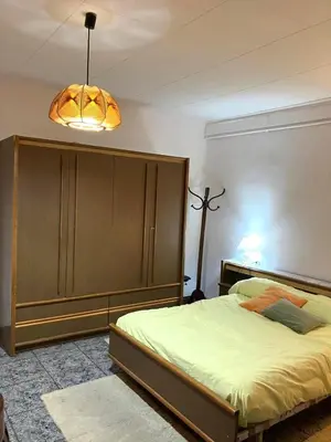 a bedroom with a large bed and a large cabinet at Casa EMILIO in Olesa de Montserrat