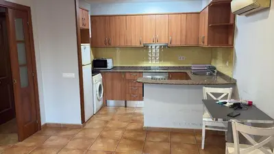 a kitchen with wooden cabinets and a counter top at Calle Ramon Berenguer Iv, 13, Sant Pere de Ribes barcelona 08812 in Vilanova i la Geltrú