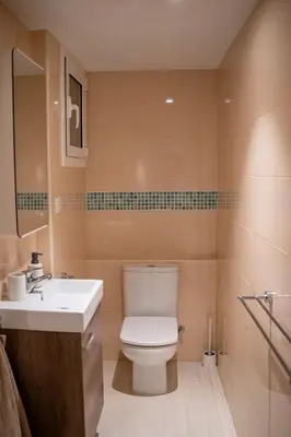 a bathroom with a white toilet and a sink at Apartment in Ciutat Vella Born in Barcelona