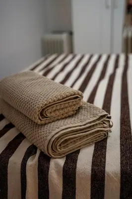 two folded towels sitting on top of a bed at Apartment in Ciutat Vella Born in Barcelona