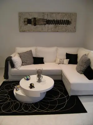 a living room with a white couch and a coffee table at Blanca Subur in Sitges