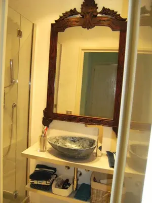 a bathroom with a sink and a large mirror at Blanca Subur in Sitges