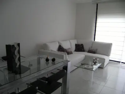 a living room with a white couch and a glass table at Blanca Subur in Sitges