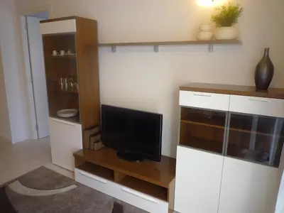 a living room with a tv on a wooden entertainment center at 3-Apartament full equiped, next to Mobile Congres in Hospitalet de Llobregat