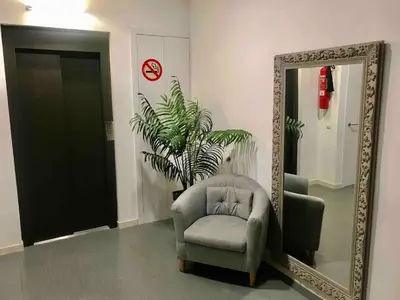 a mirror and a chair in a room at 3-Apartament full equiped, next to Mobile Congres in Hospitalet de Llobregat