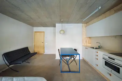 a small kitchen with a blue table in a room at Mooeve Montjuïc in Barcelona