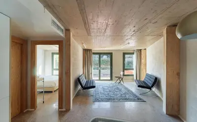 a room with two chairs and a bed at Mooeve Montjuïc in Barcelona