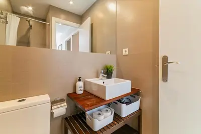 a bathroom with a sink and a mirror at Marblau Beach Vacation and Downtown Sitges in Sitges