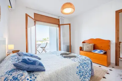 a bedroom with a bed and a large window at Can Montardo in Sant Pere de Ribes