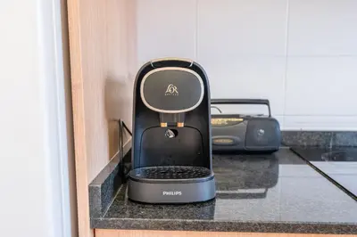 a black iron sitting on a counter with a toaster at Can Montardo in Sant Pere de Ribes