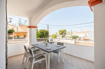 a table and chairs on the balcony of a house at Can Montardo in Sant Pere de Ribes