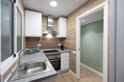a kitchen with a sink and a stove at Stay U-nique Apartment Passeig d´Amunt in Barcelona