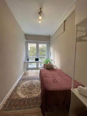 a bedroom with a bed and a large window at Centric Apartment with Balcony in Barcelona