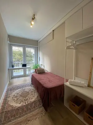 a bedroom with a bed and a large window at Centric Apartment with Balcony in Barcelona
