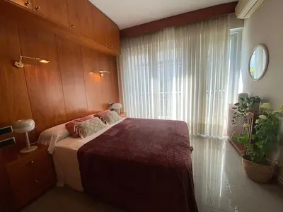 a bedroom with a bed with a large window at Centric Apartment with Balcony in Barcelona