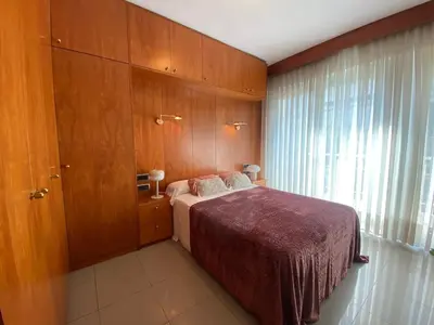 a bedroom with a bed and a large window at Centric Apartment with Balcony in Barcelona