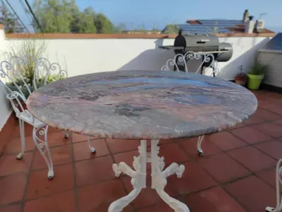 a stone table sitting on top of a patio at Suite de invitados independiente in Cerdanyola del Valles