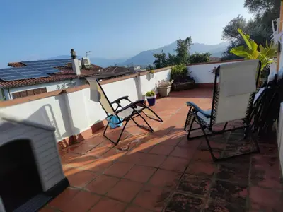 two chairs sitting on the roof of a house at Suite de invitados independiente in Cerdanyola del Valles