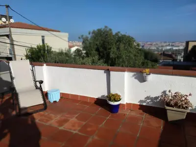 a patio with twootted plants and a fence at Suite de invitados independiente in Cerdanyola del Valles