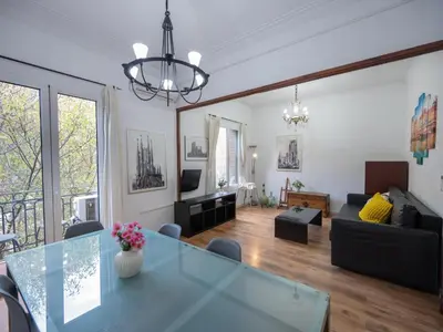 a living room with a table and a couch at Apartment amazing Sagrada familia view II in Barcelona