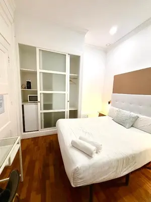 a bedroom with a white bed with two towels on it at Hotelito Luxe in Barcelona