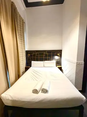 a bedroom with a bed with two towels on it at Hotelito Luxe in Barcelona