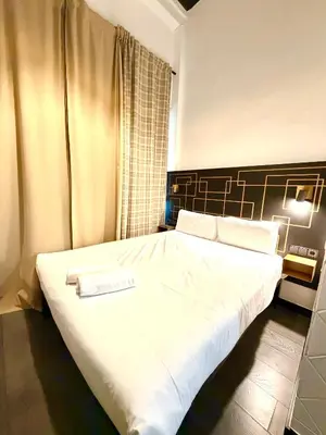 a bedroom with a large white bed with a sign on it at Hotelito Luxe in Barcelona