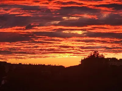 a sunset with the sun setting in the sky at Shambala B&B in Sitges