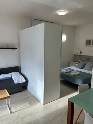a bedroom with a bed and a large sliding door at Apartamentos ELMA1 in Castelldefels